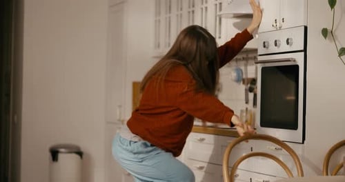 Cheerful Woman Dancing Freely in Her Kitchen