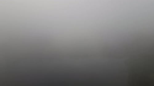 Flying Through The Fog And Clouds Over The River In The Early Morning. - aerial shot