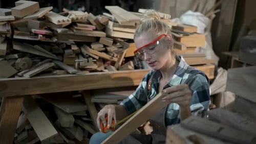 Carpenter is working at workshop.