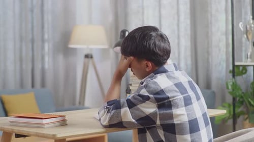 Back View Of Tired Teenager Having Headache While Learning At Home