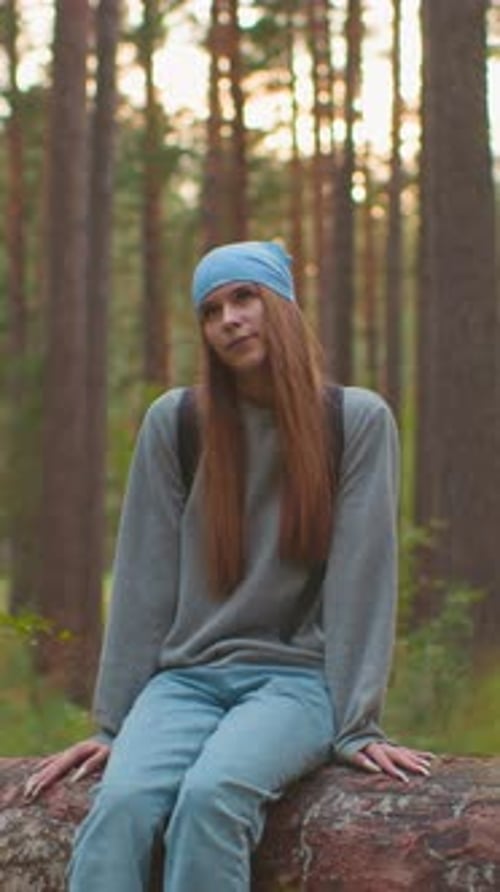 Friends Relaxing on Fallen Tree in Serene Forest