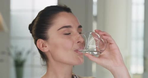 Beautiful Woman Drinking Glass of Water Smiling