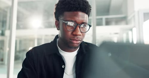 Young man working on computer in modern office