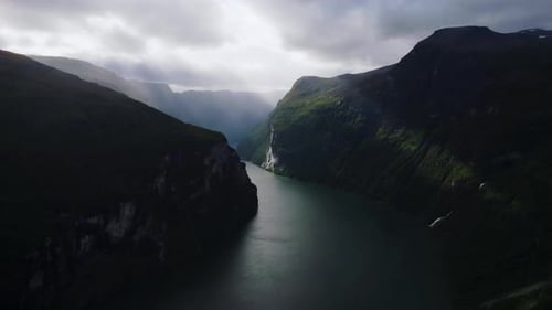 Aerial view of Geirangerfjord with steep cliffs, blue water, waterfalls, mountain landscape scenery