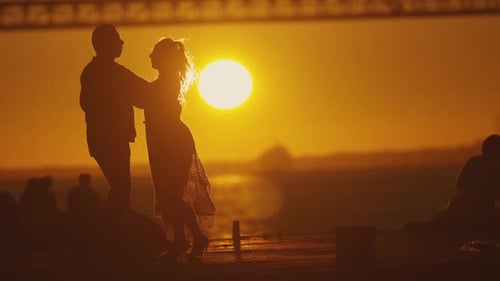 Couple Dancing in Silhouette at Sunset