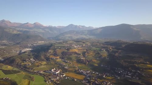 Aerial View of Green Meadows with Villages and Forest in Austrian Alps Mountains