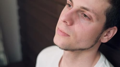 Close Up Portrait of a Young Teenager Man Looking at Camera with an Insecure Expression Against a