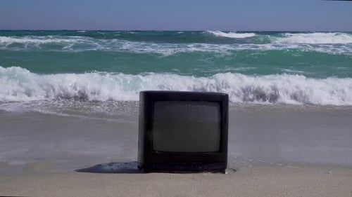 A TV on the beach. Breaking waves on the background. For TV mockup.