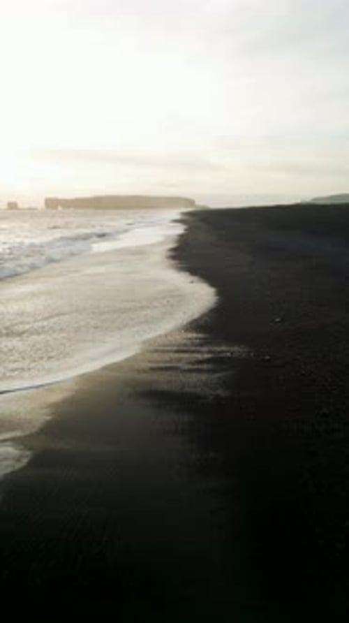 Aerial view of black sand beach in Iceland in winter.