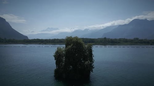 A Picturesque Nature Landscape with an Isolated Island Surrounded By Majestic Mountains