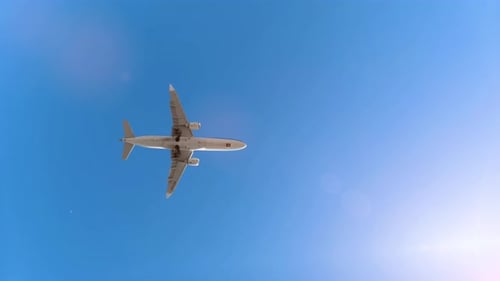 Airplane Flying Through a Blue Sky