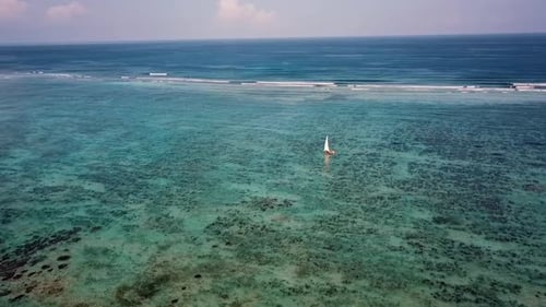 Perfect aerial flight panorama curve flight drone shot of a lonely sailboat with white sails.
Paradi