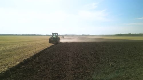 Tractors plowing the field in Ukraine