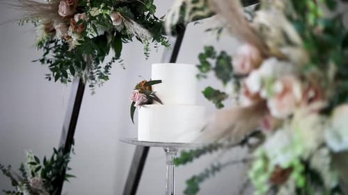 Elegant Two-Tiered Wedding Cake with Floral Arch