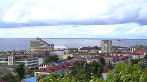 Contemporary City Near Tranquil Sea Bay Under Cloudy Sky