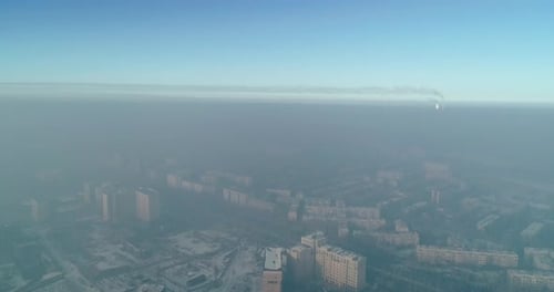 Aerial view of polluted city covered with smog