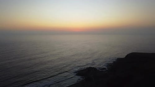 Drone 4k footage of a sunset sky after the sun has gone down. Slowly flying backwards.