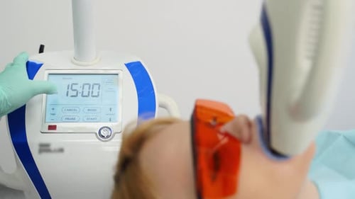 Closeup of Whitening Machine Screen Dentist Launching Whitening Device with Digital Screen in a