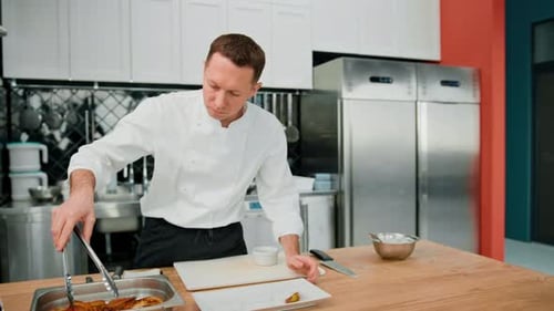 Chef Plating Food in a Commercial Kitchen