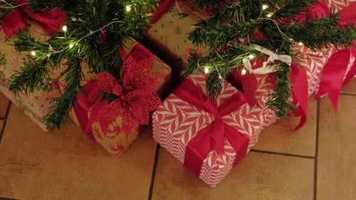 Big Wrapped Gift Boxes Is Under the Christmas Tree Pink and Gold GiftWrapped Box with Ribbon for