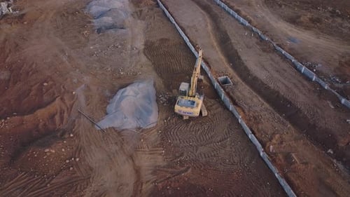 Excavator Digging Trench at Construction Site