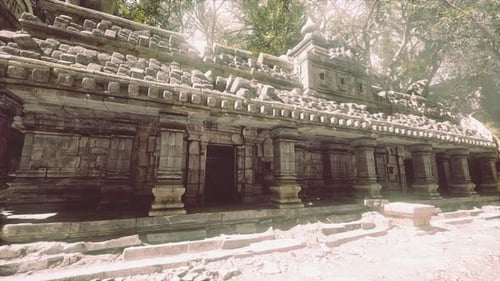 Ancient Temple Ruins in Cambodia Surrounded By Lush Greenery at Midday
