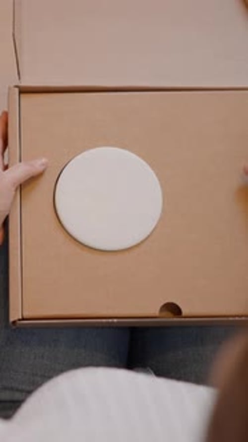 Selfemployed Woman Entrepreneur Packaging Product in a Box or Parcel for Delivery Over the Shoulder