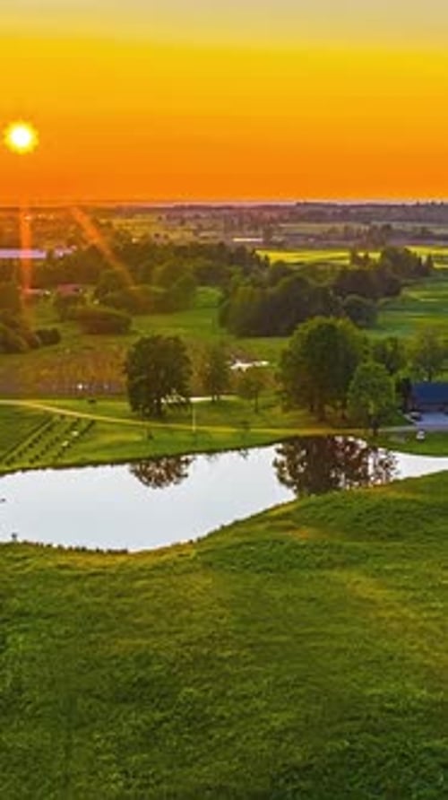 Captivating Timelapse of a Golden Sunset Over a Peaceful Rural Lake Landscape