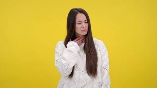 Woman with Sore Throat on Yellow Background