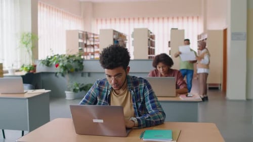Young International Students Studying in Library