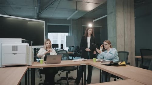 Collaborative team in modern office working on documents with slow motion highlights