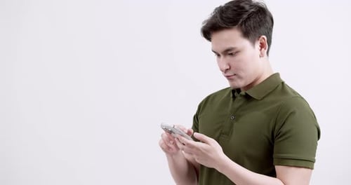 Close up of young man with smartphone in minimalist studio a modern personal moment