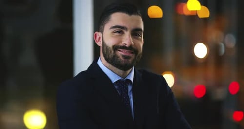 Face, smile and business man in office, confident and work on deadline at night in workplace