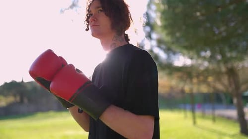 Boxer Training with Boxing Gloves in a Park
