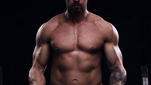 Fit and Sporty Bodybuilder Over Black Background Bodybuilder Training Using Barbell The Concept of