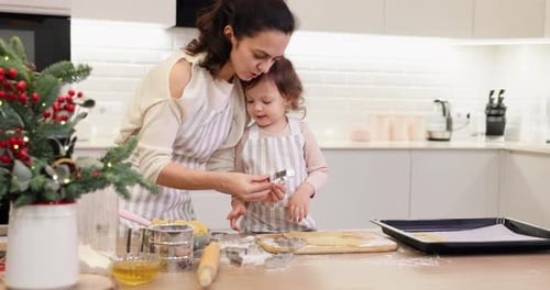 Mother and Little Child Daughter Cutting Cookies of Raw Gingerbread Dough