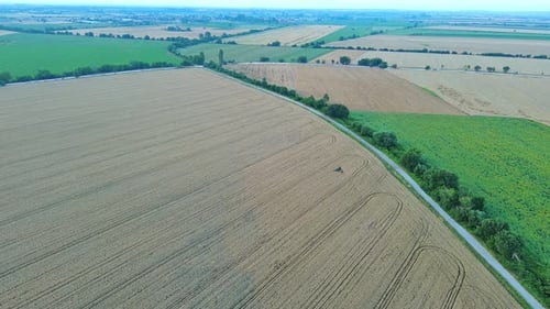 Highway with Cars Passes Through Fields Between Mountain Valleys of Rhodope Mountains
