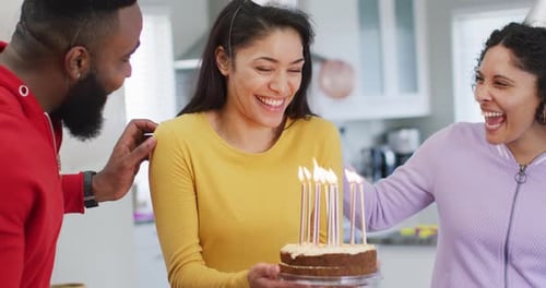 Friends Celebrate Birthday with Cake and Party Hats