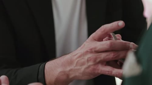 magician’s hands performing card trick in close up motion