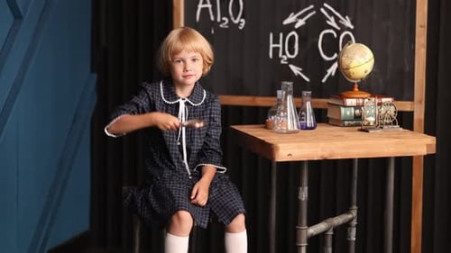 Blonde Child Looks Through a Magnifying Glass