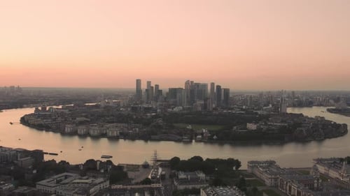 Wide angle sunset Aerial of the Canary Wharf buildings in London at Greenwich park