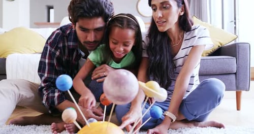 Family Learning About Planets Together Indoors