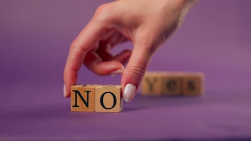 Wooden Blocks Spell Yes and No on Purple