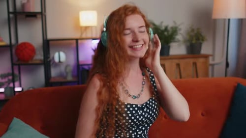 Woman with Headphones Listening to Music at Home