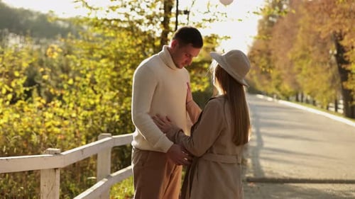 Young stylish couple lovers are hugging and kissing in the autumn park. Lovely romantic moment