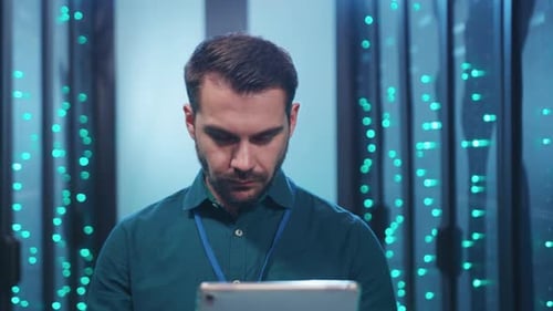 A Focused Professional Engaged in Analyzing Data on a Tablet Within a Futuristic Environment