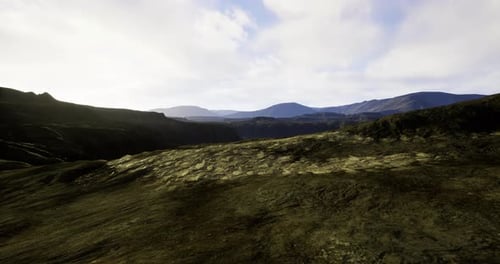 Stunning View of Rocky Terrain with Mountains Under a Bright Sky at Sunset