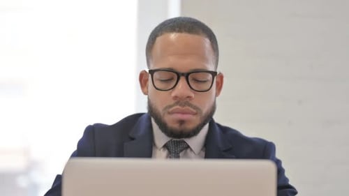 Close Up of African Businessman Working on Laptop