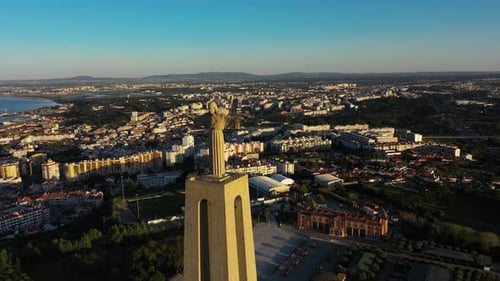 Aerial video around a sunny day walk on Jesus the King in the Alameda in the city of Lisbon