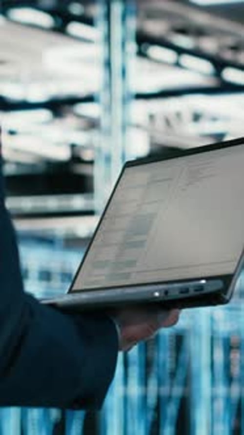 Vertical Video Close Up of Data Center Engineer Using Laptop to Code